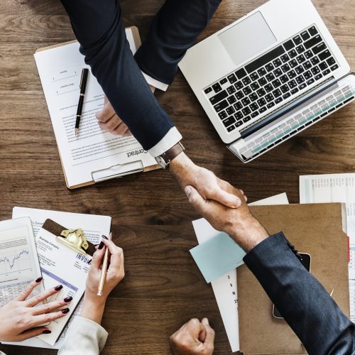 Business people shaking hands together Business people shaking hands together